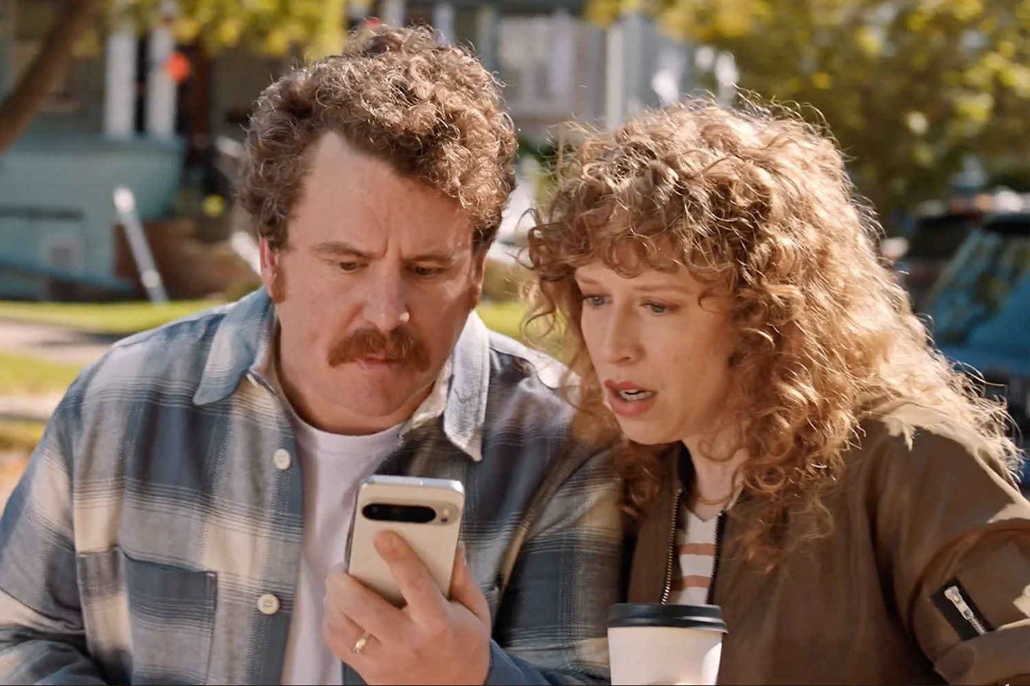 Scott Watson and Amanda Lea Mason reacting to last-minute NFL ticket prices on a phone in the Ticketmaster commercial.