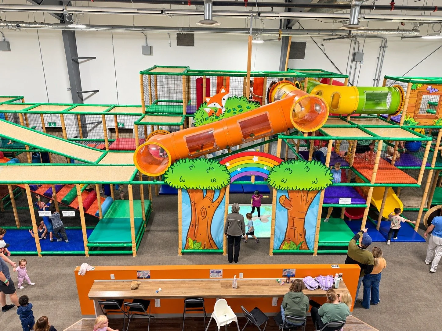 The forest-themed multi-level play structure at Flynn’s Forest