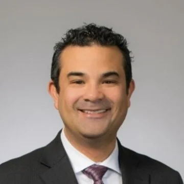 portrait of a latino man in a business suit