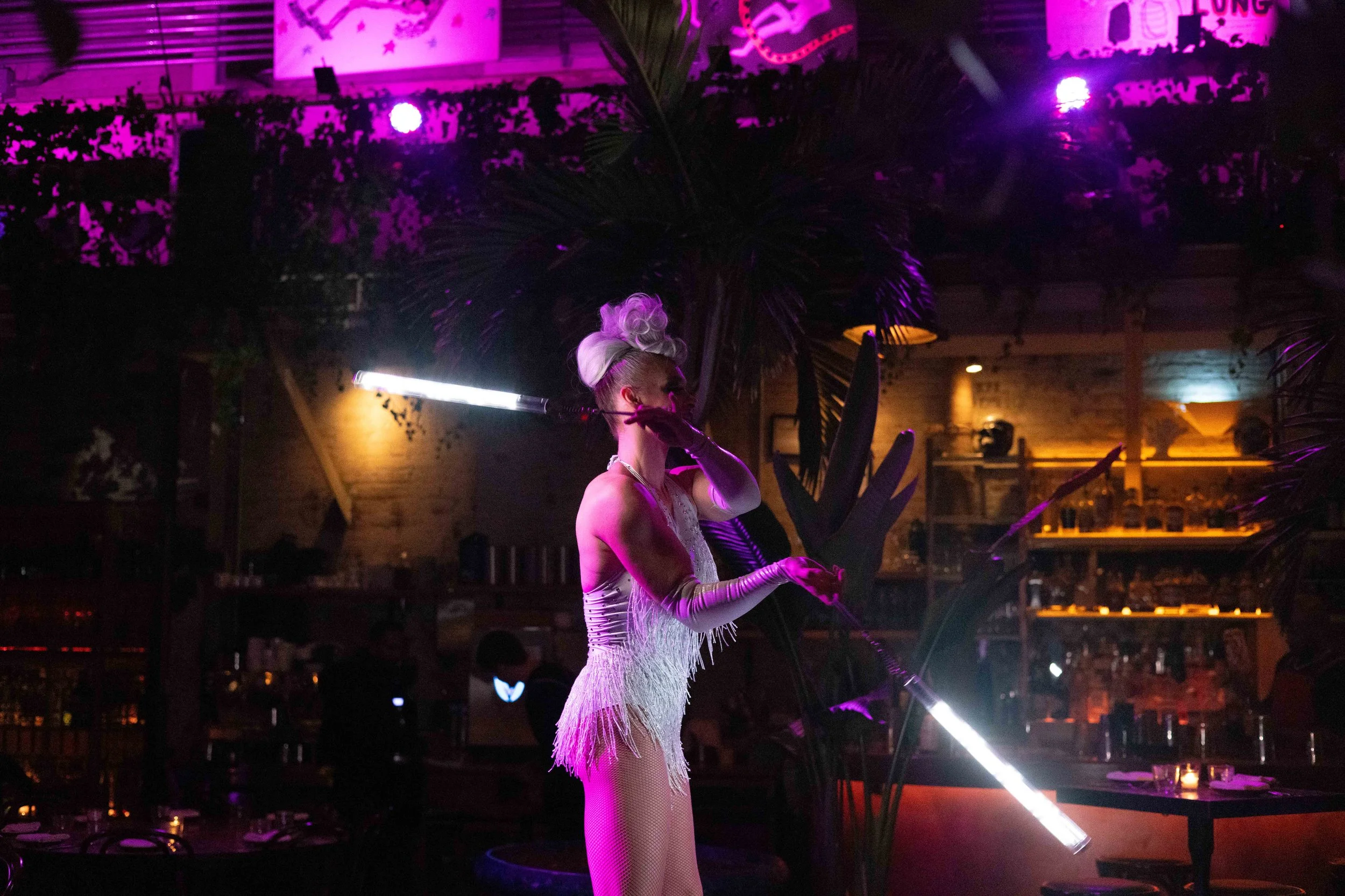 LED poi performance creating patterns of light at an event