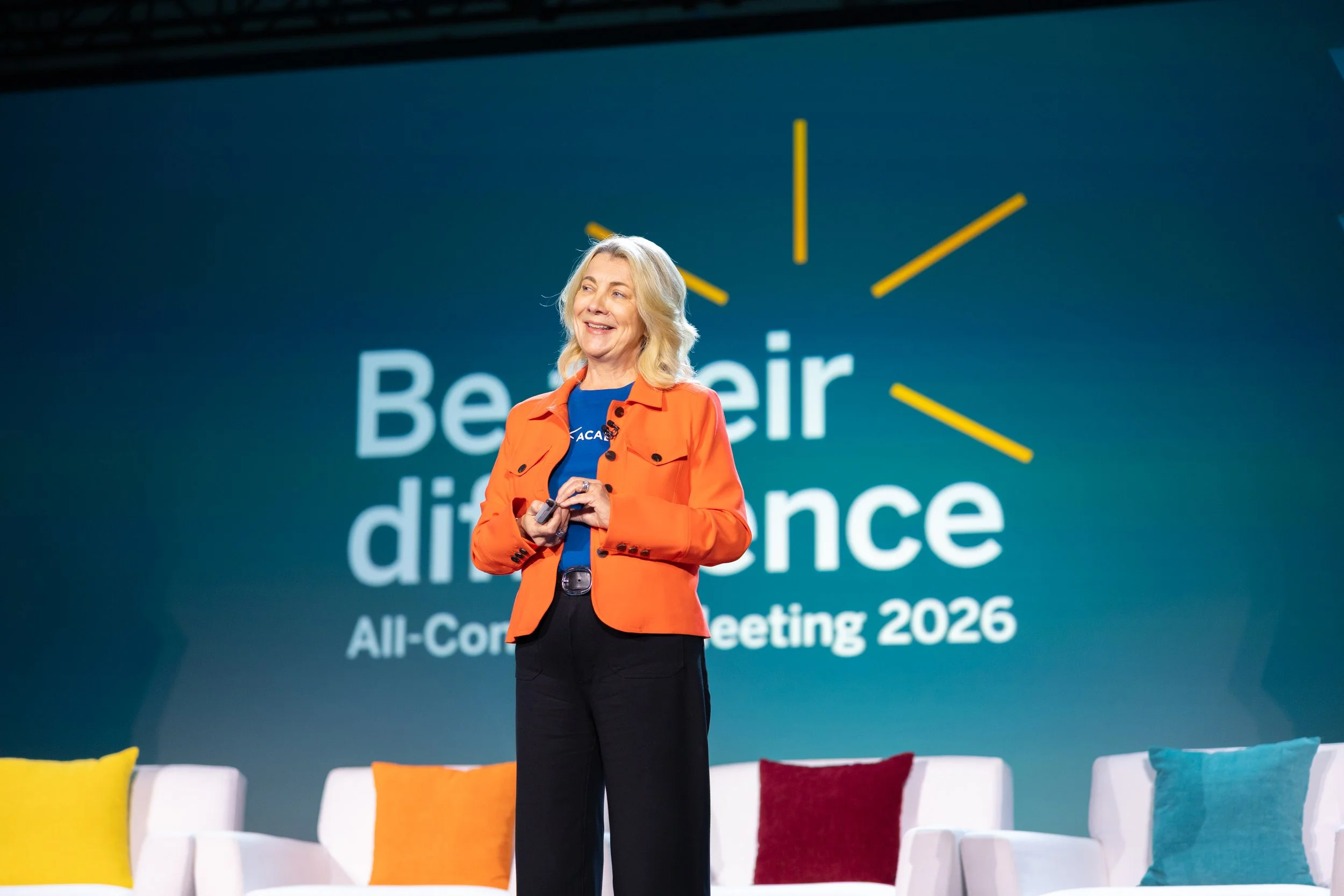 Keynote speaker on the main stage at a corporate conference