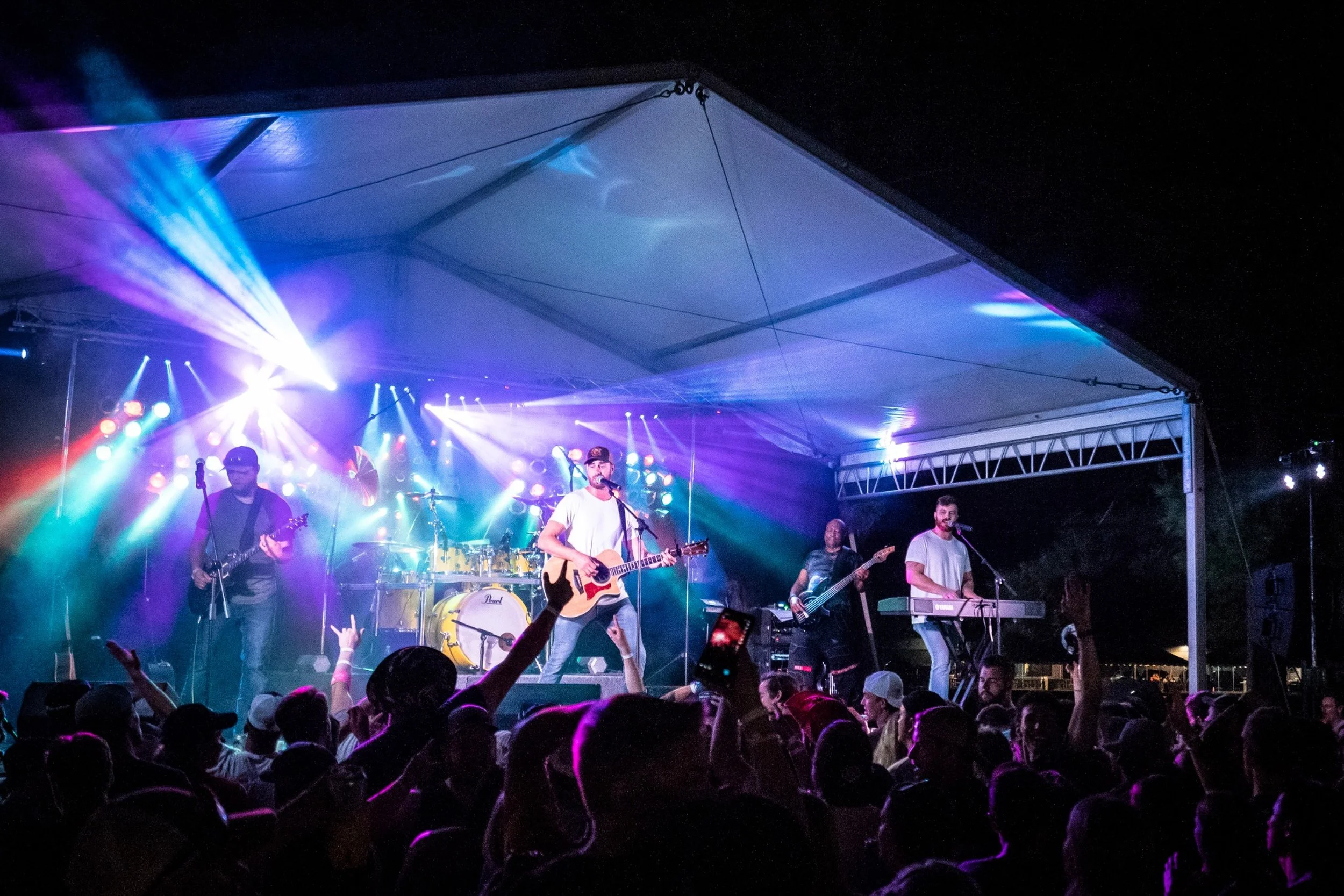 Ben Johnson performing with his full band for a festival crowd