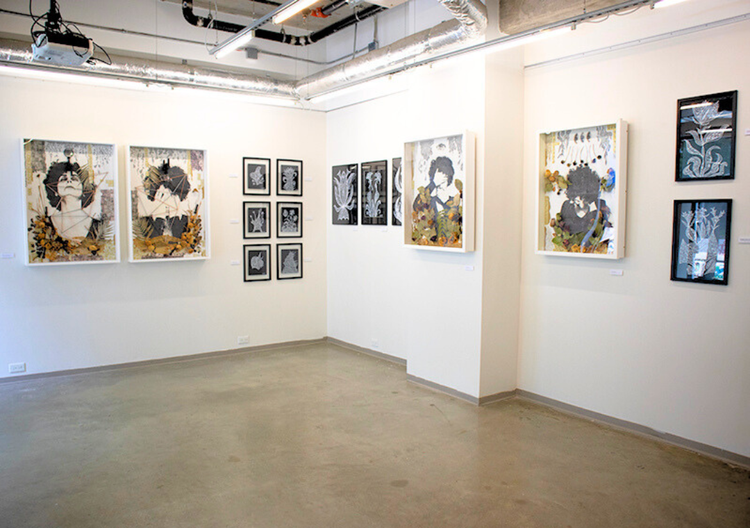 Remote Gallery interior of Gallery B with framed artwork hanging on the white walls, bright overhead lighting and polished concrete flooring. 