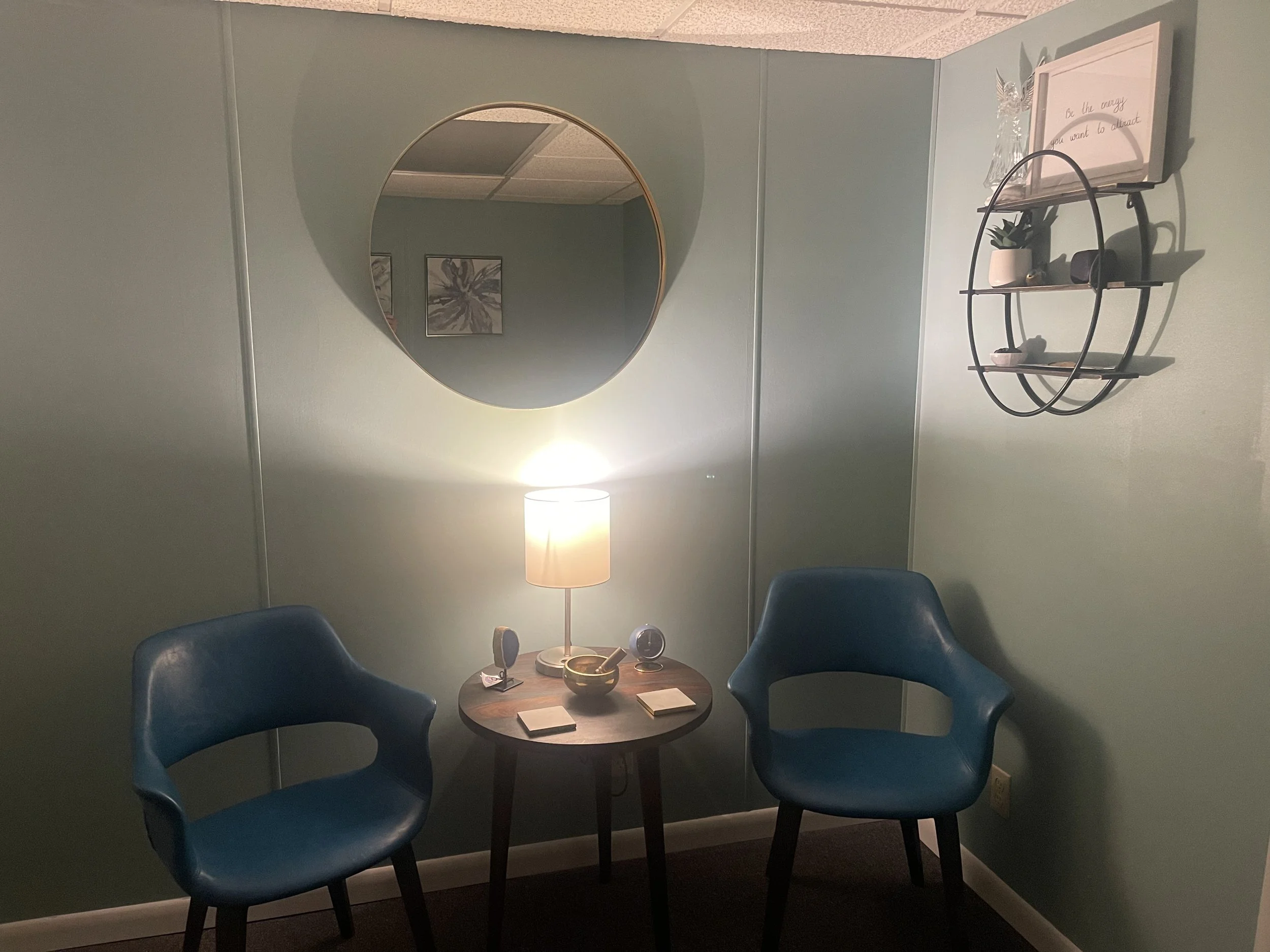 Reiki consultation room with blue chairs and singing bowl