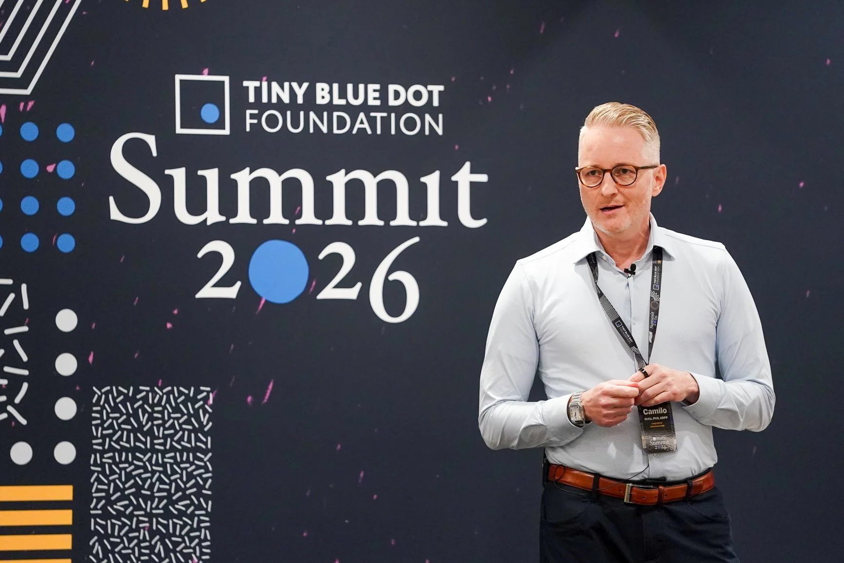 Dr. Camilo Ortiz speaking at the Tiny Blue Dot Foundation Summit 2026