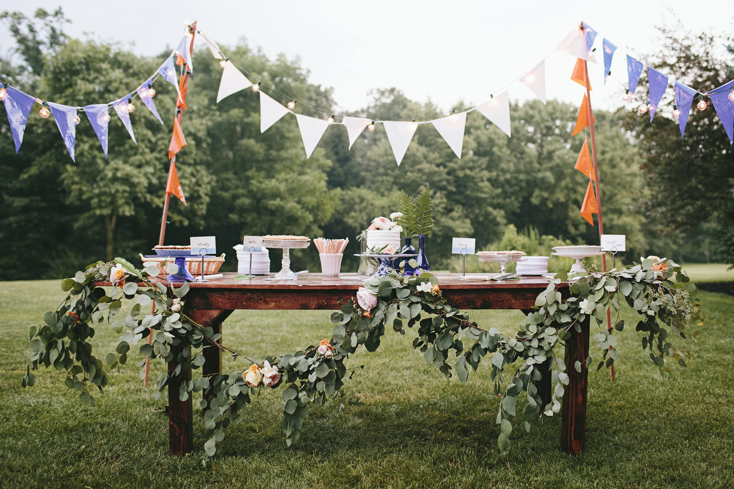 Elegant fundraiser setup with farmhouse tables and ambient lighting