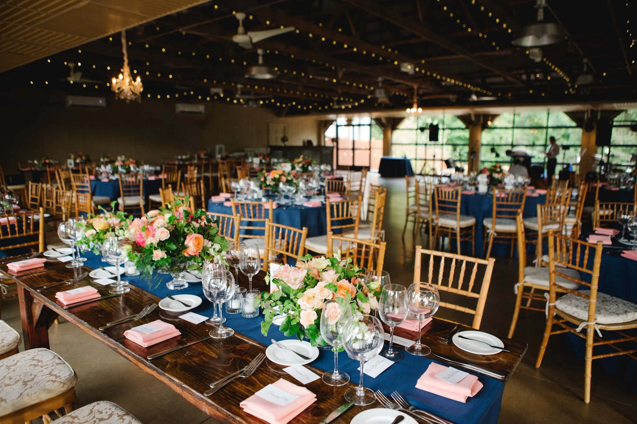 Elegant gala setup with farmhouse tables and ambient lighting