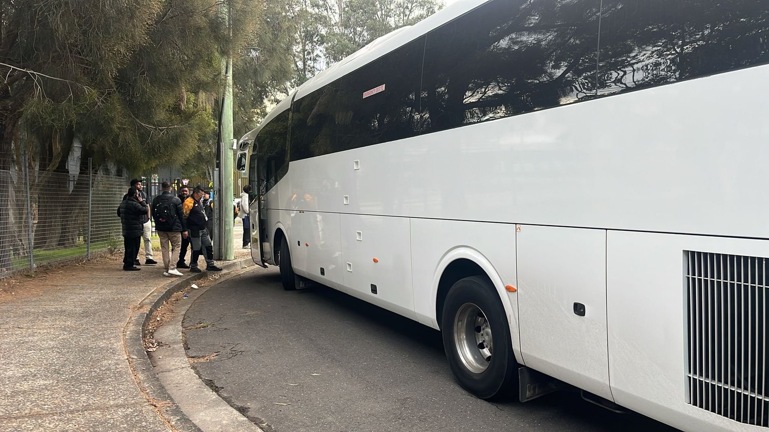 A Sydney work group beside their Urban Legends coach ready for a Christmas party venue crawl