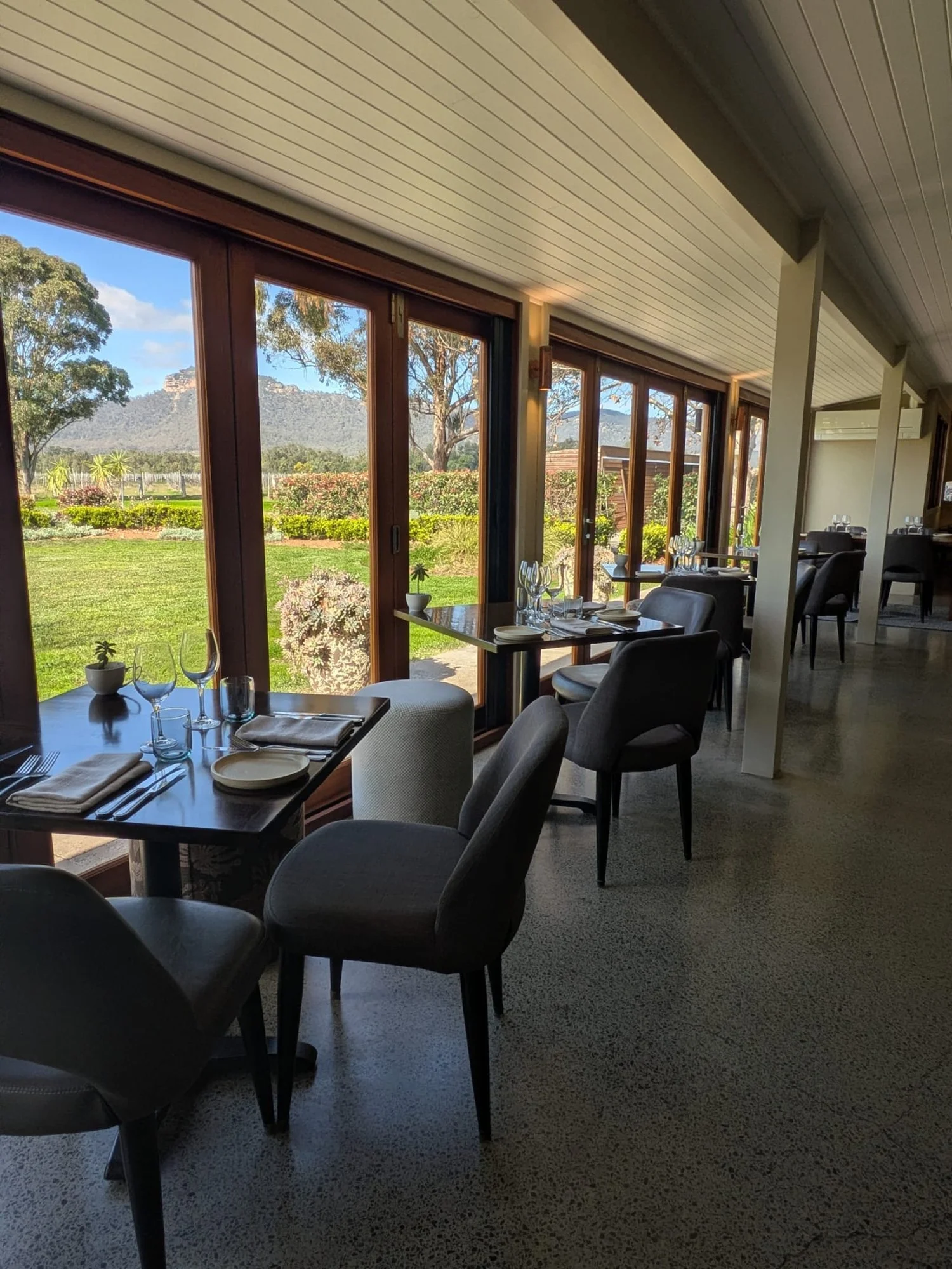 Vineyard-view restaurant dining room set for a Hunter Valley work Christmas long lunch