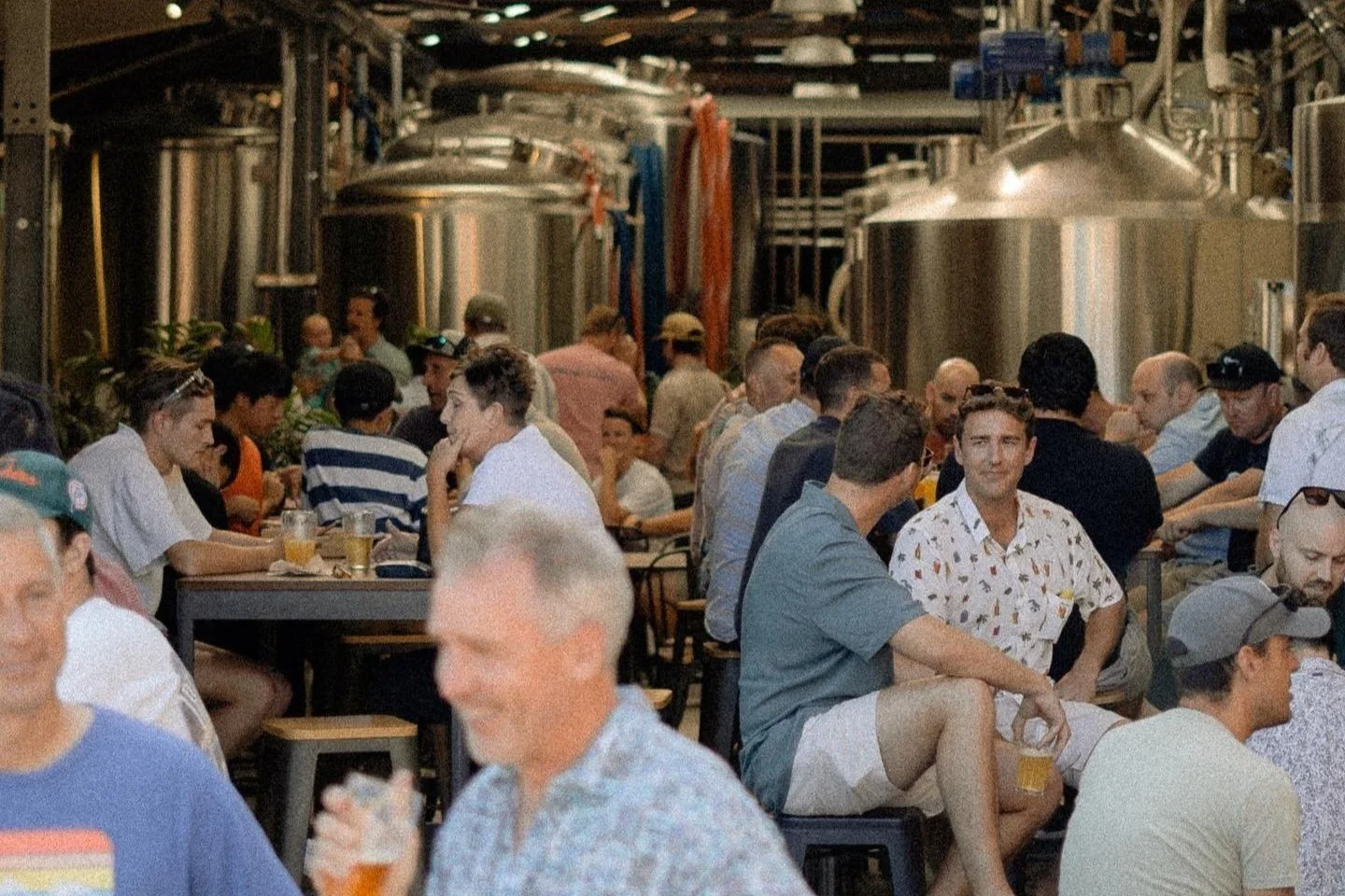 Guests enjoying craft beer among the tanks at Principle Brewing in Wollongong