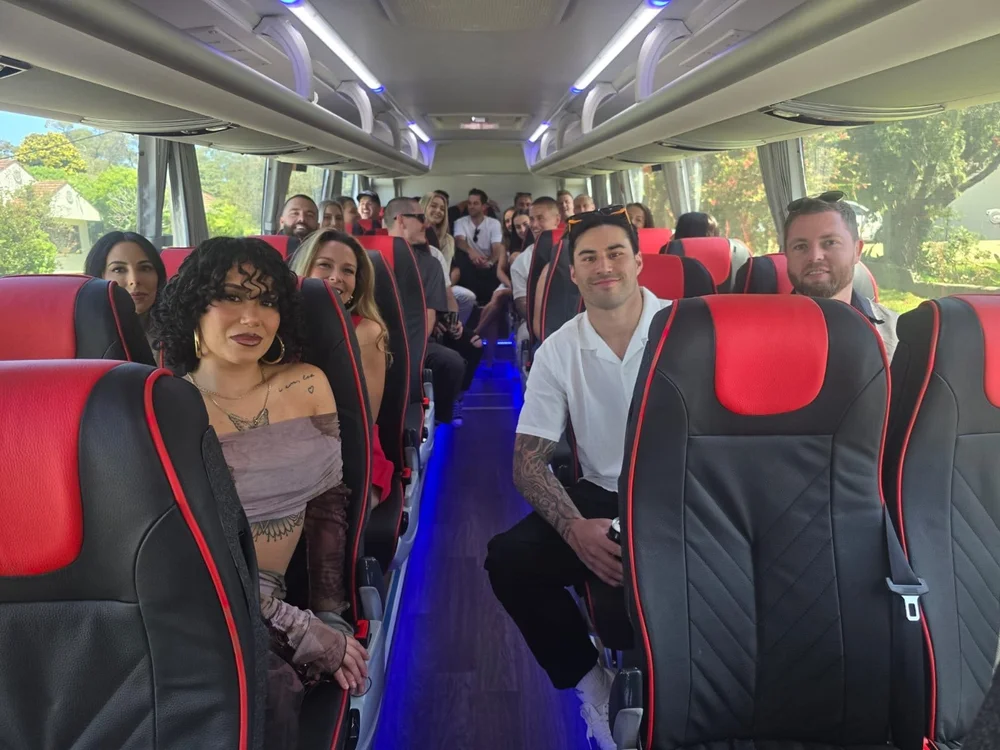 Decorated wedding bus interior, guests celebrating on board