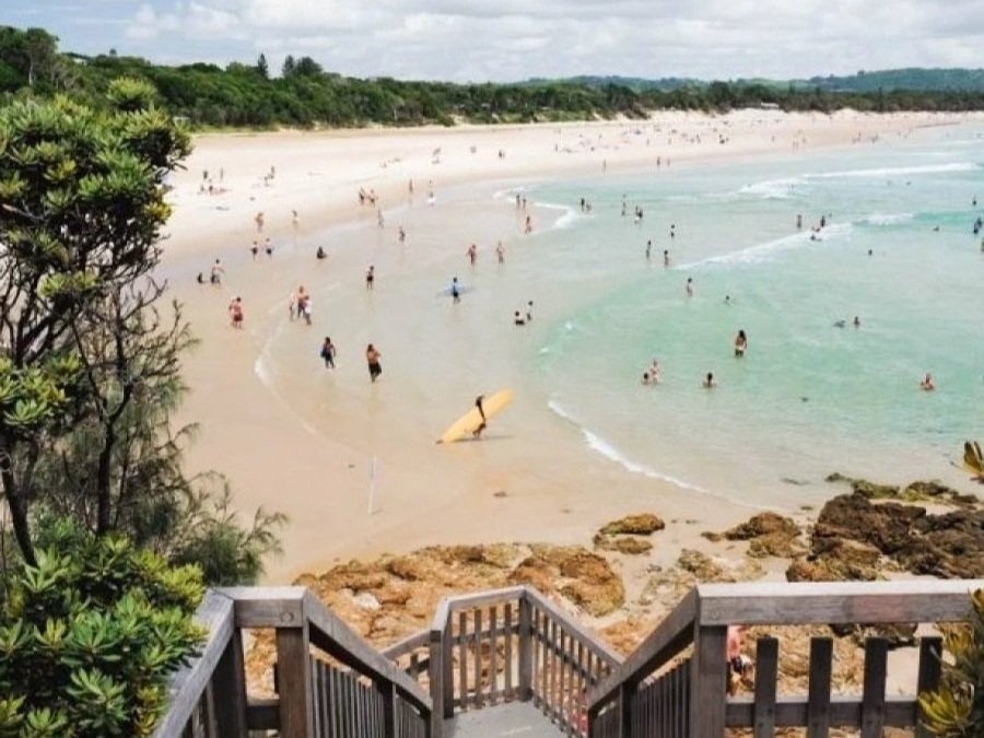 Byron Bay Main Beach and the coastal boardwalk on a clear day