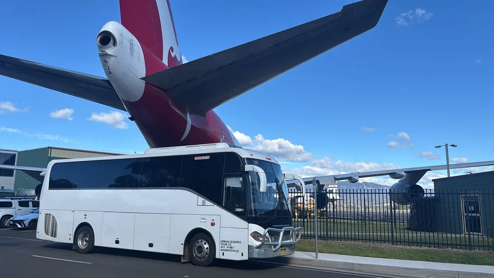 Urban Legends Mercedes Sprinter parked at an aviation museum on a NSW group charter