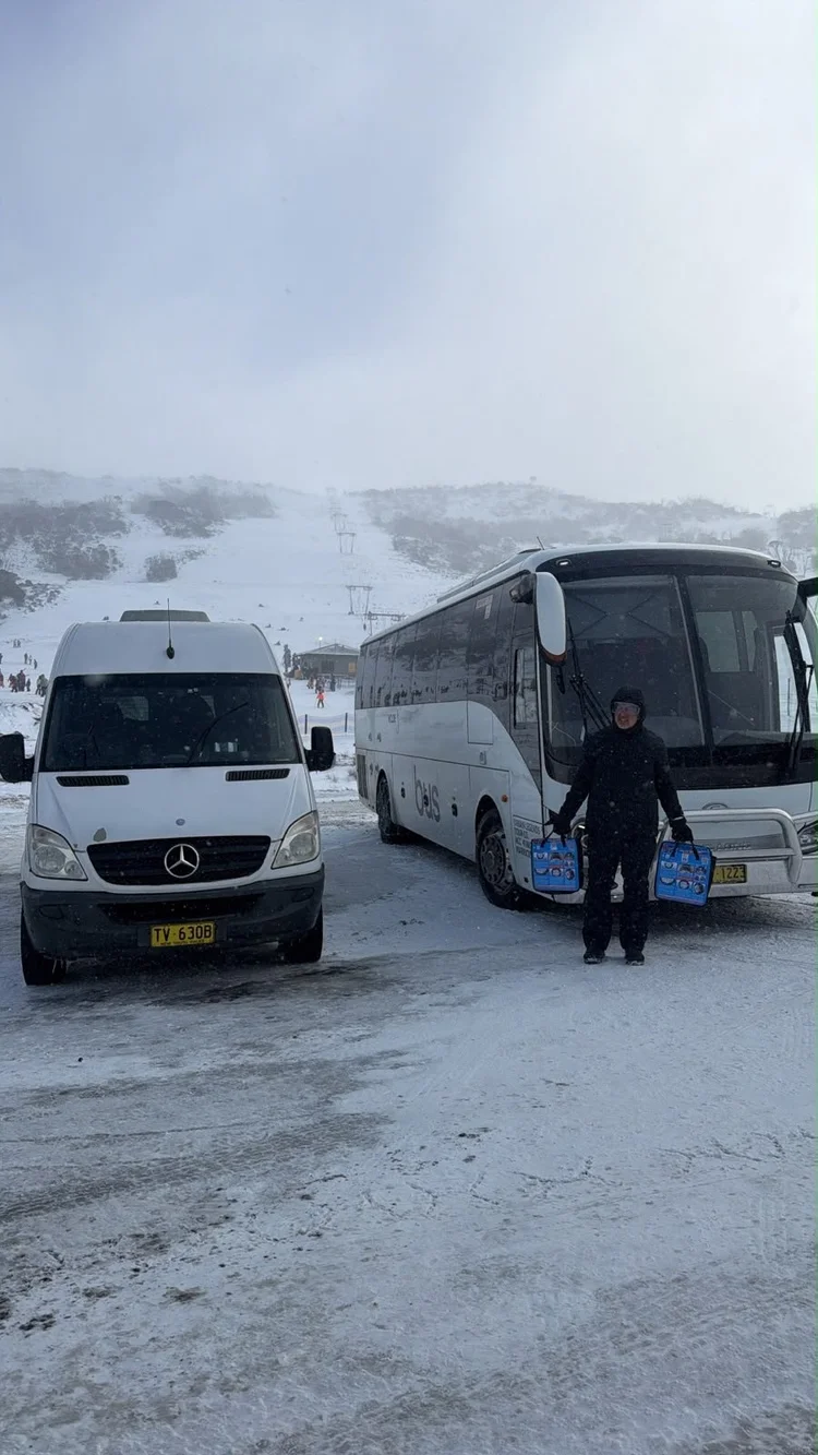 Urban Legends driver with the snow bus and transfer van at Perisher