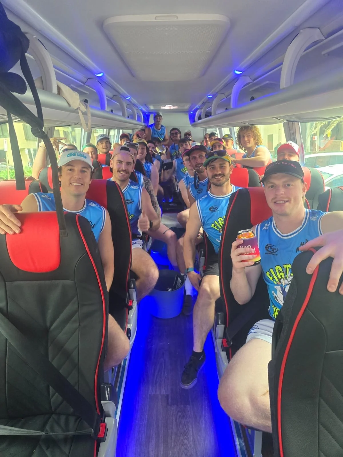 Sporting team celebrating together on board an Urban Legends minibus, Wollongong charter