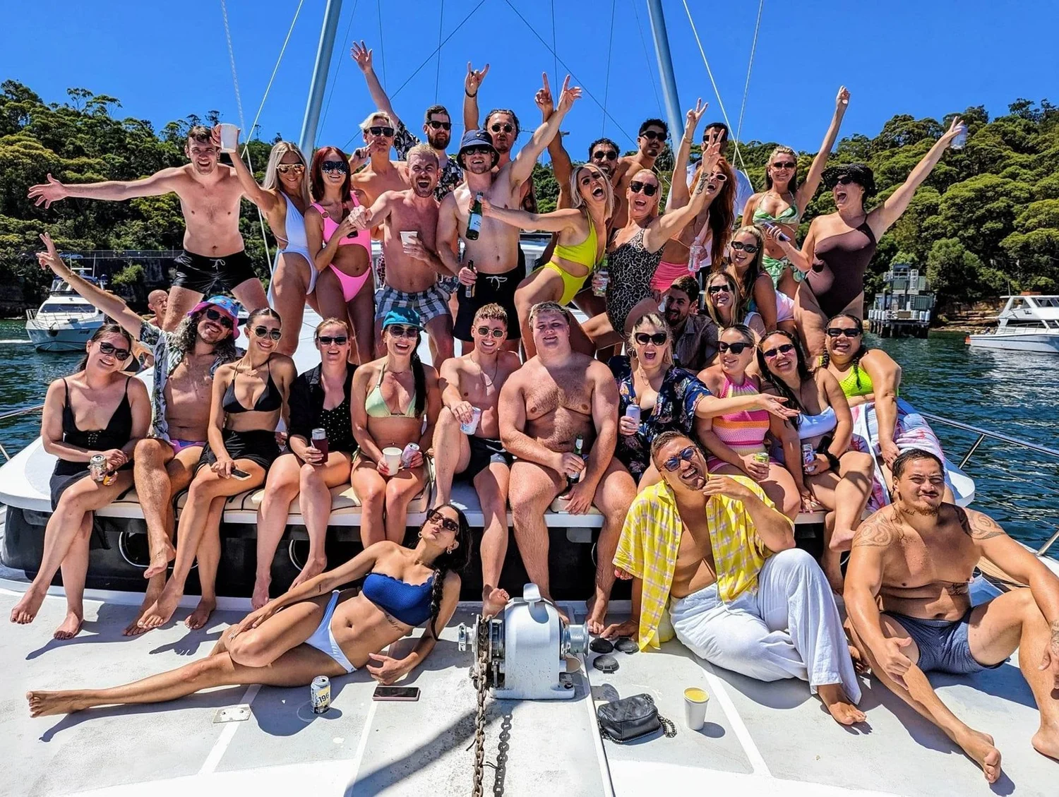 A party crowd on the deck of the power catamaran Passion on Sydney Harbour