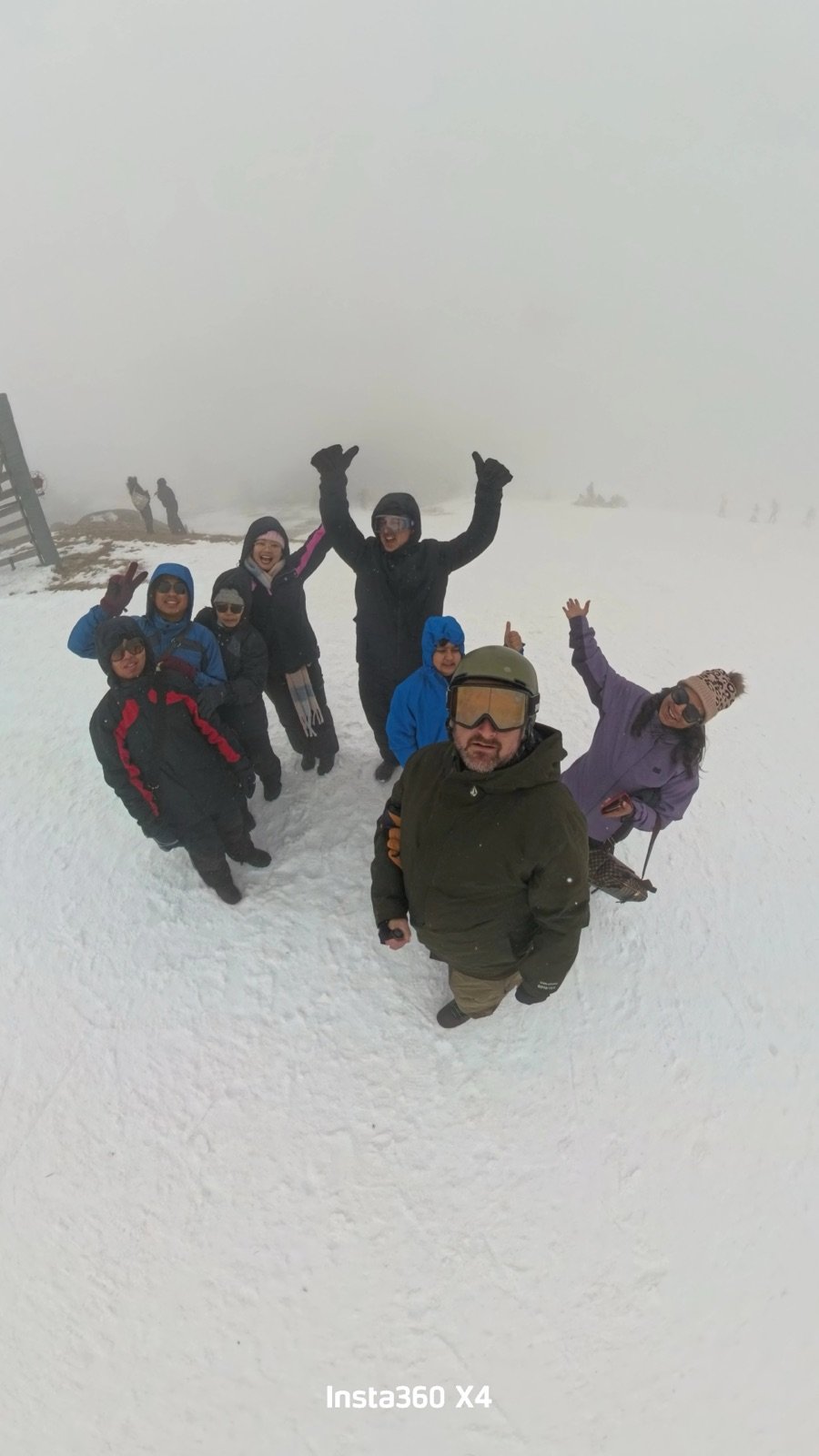 Crew celebrating on the mountain during snow play on tour