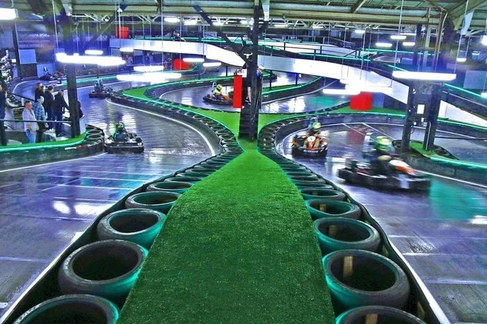 Indoor go kart track in Brisbane lit in neon with karts on the circuit