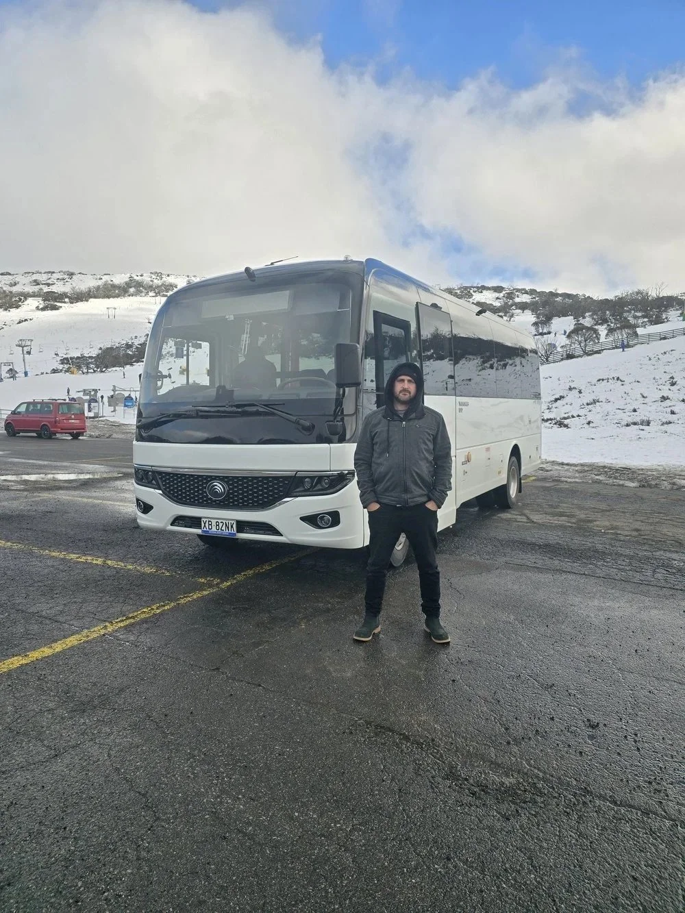 Urban Legends driver with a luxury coach parked at the Perisher slopes