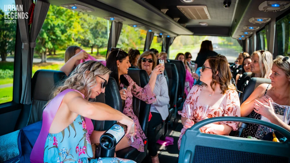 A hens party group celebrating on board an Urban Legends party bus in Sydney