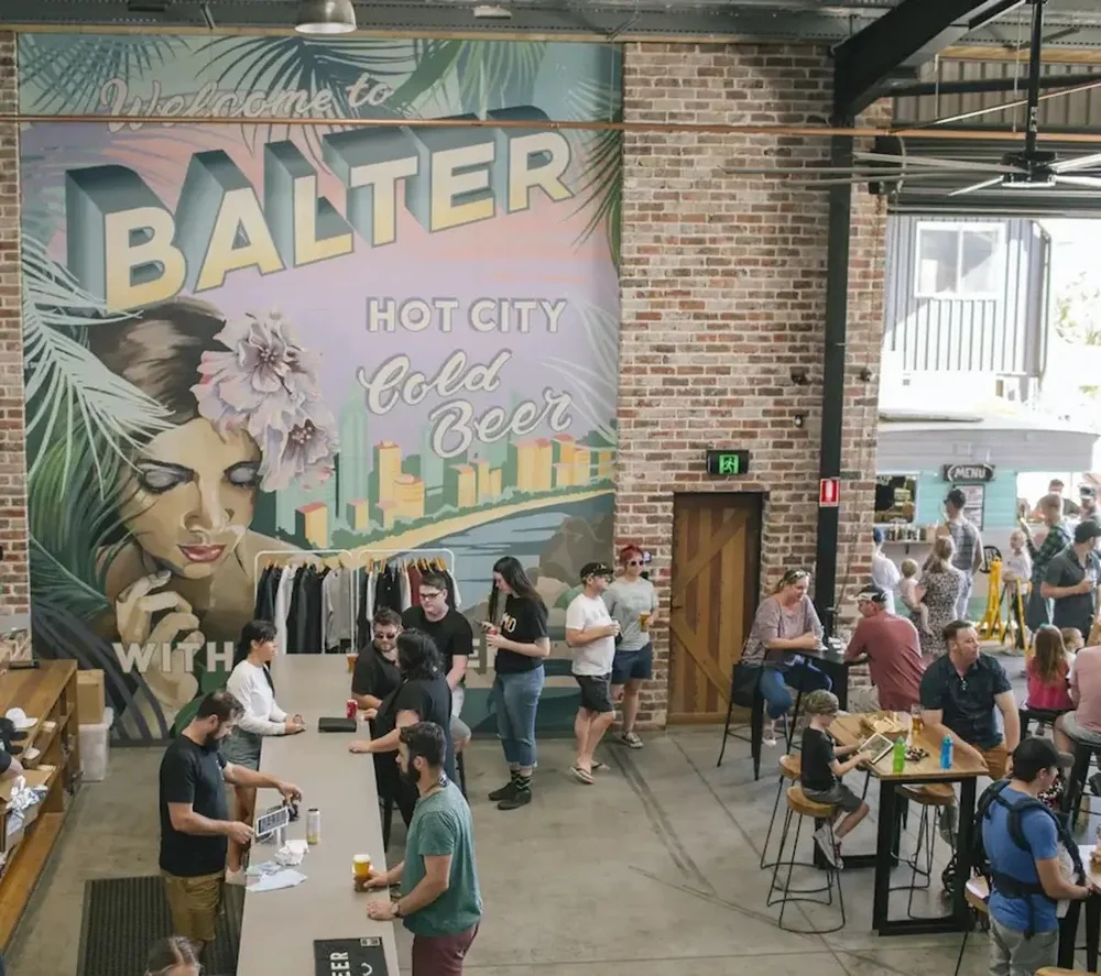 Group in the Balter Brewing taproom at Currumbin on the Gold Coast with the wall mural behind them