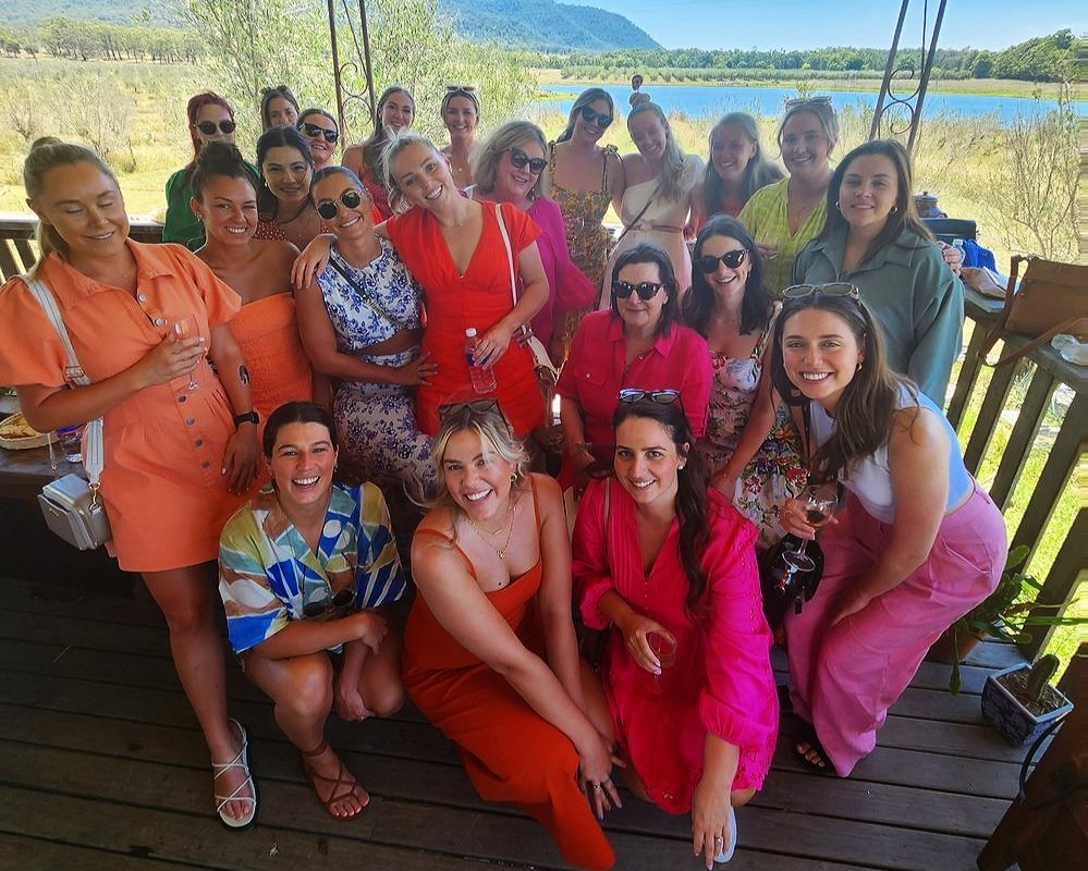 A hens party group on a Hunter Valley wine tour standing together outside a cellar door