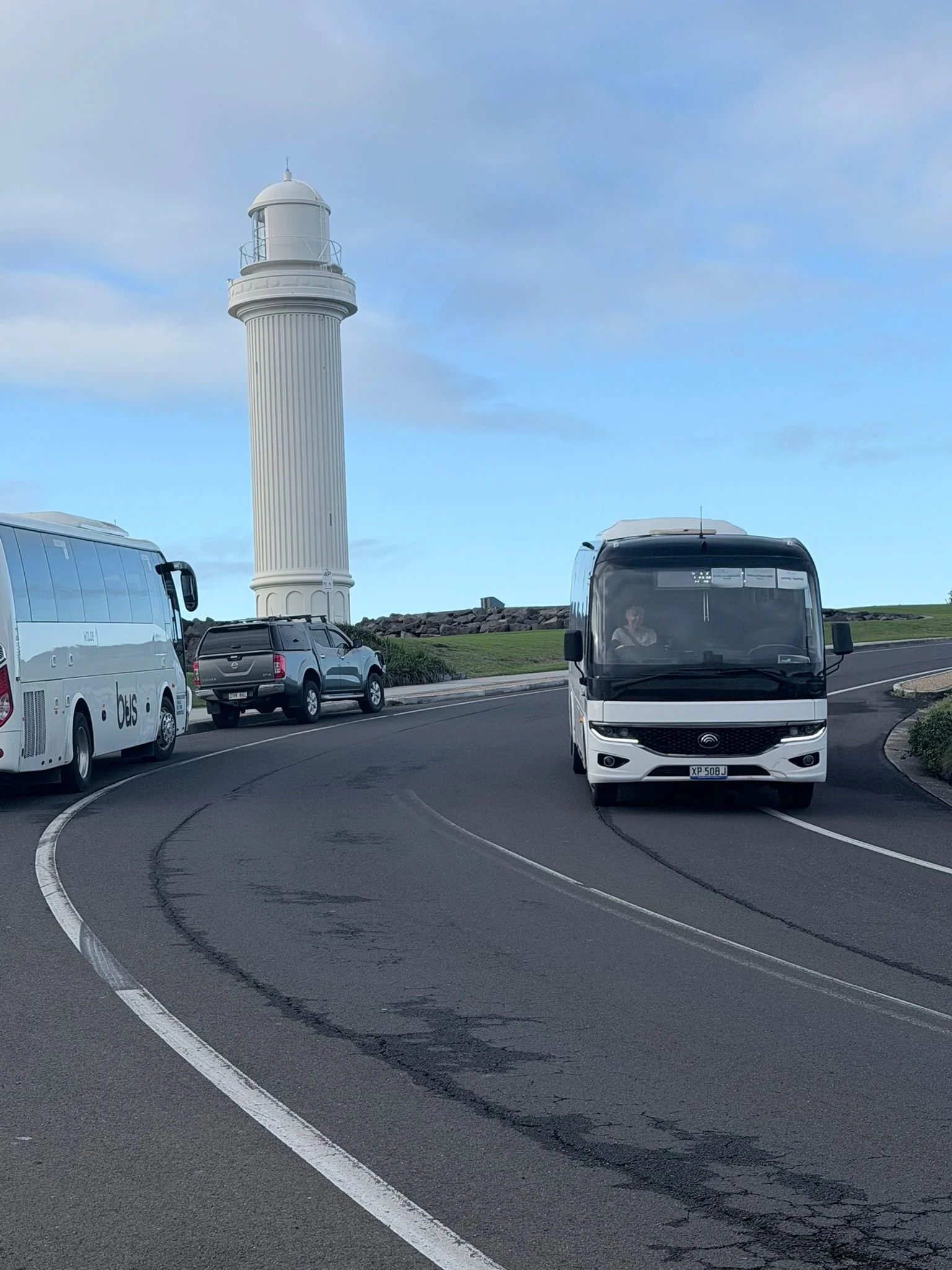 Urban Legends 27-seat coach charter driving past Wollongong Head Lighthouse