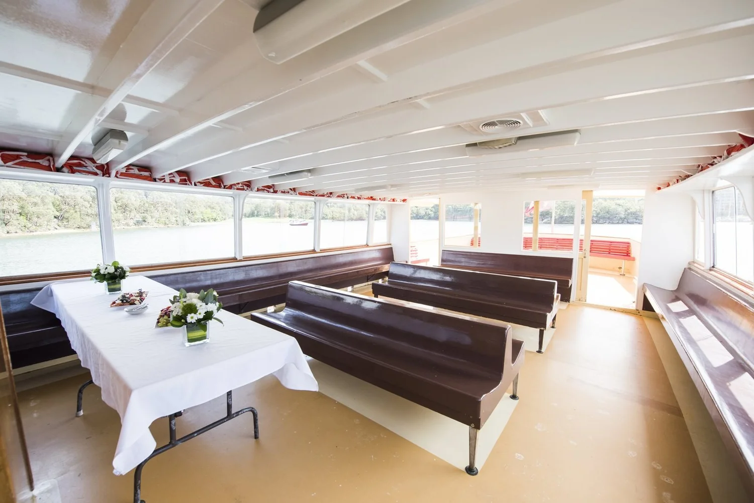 A catering table set up inside the timber cabin of a heritage ferry on Sydney Harbour
