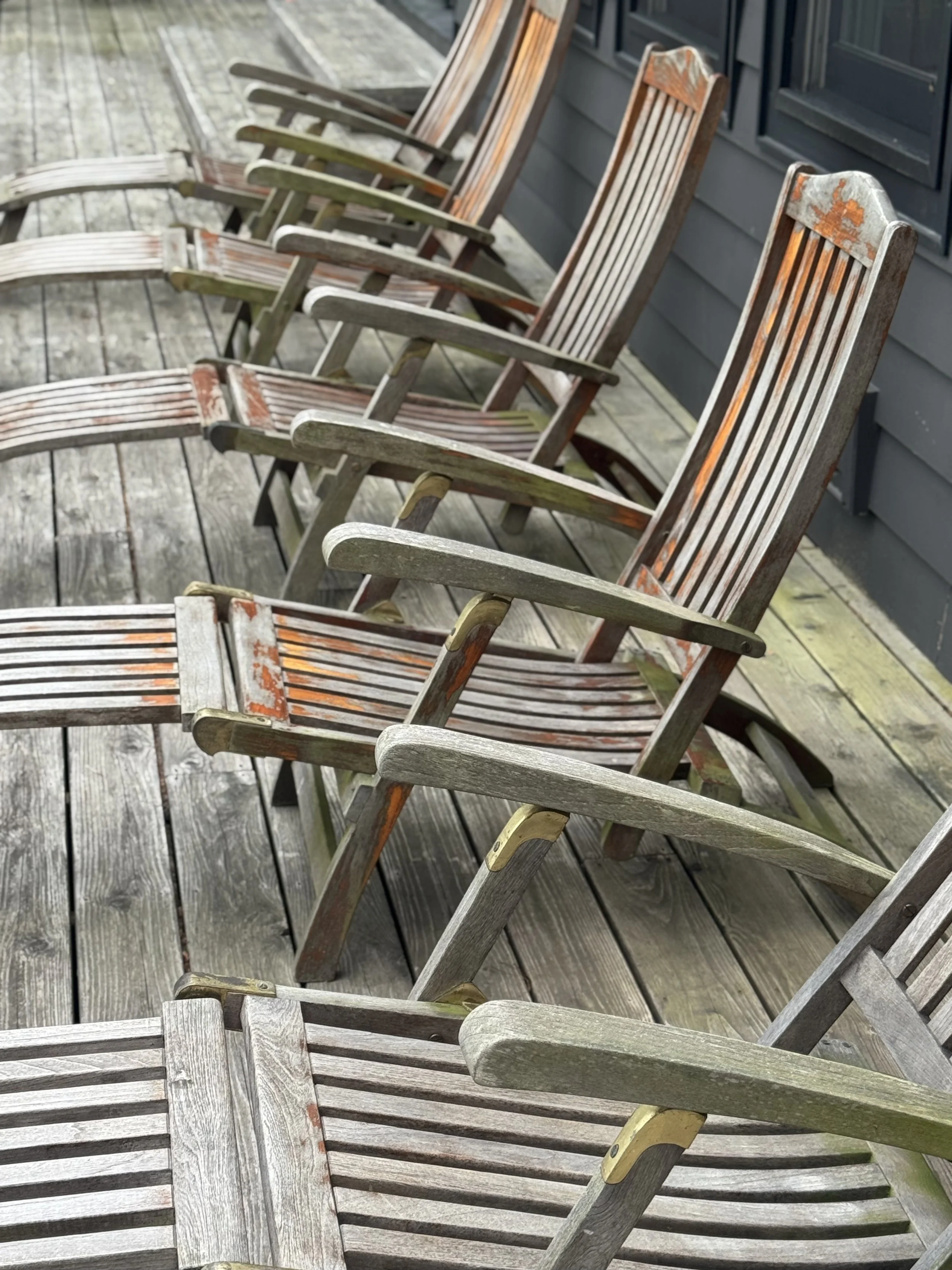 Weathered grey teak steamer chair before restoration in Port Carling, Muskoka Lakes