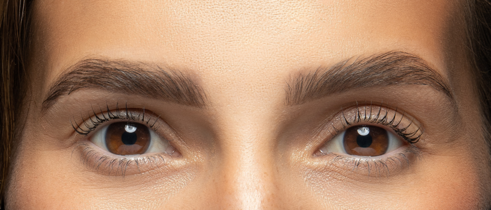 Close-up of a guest’s eyes after a lash lift — naturally lifted, curled lashes.