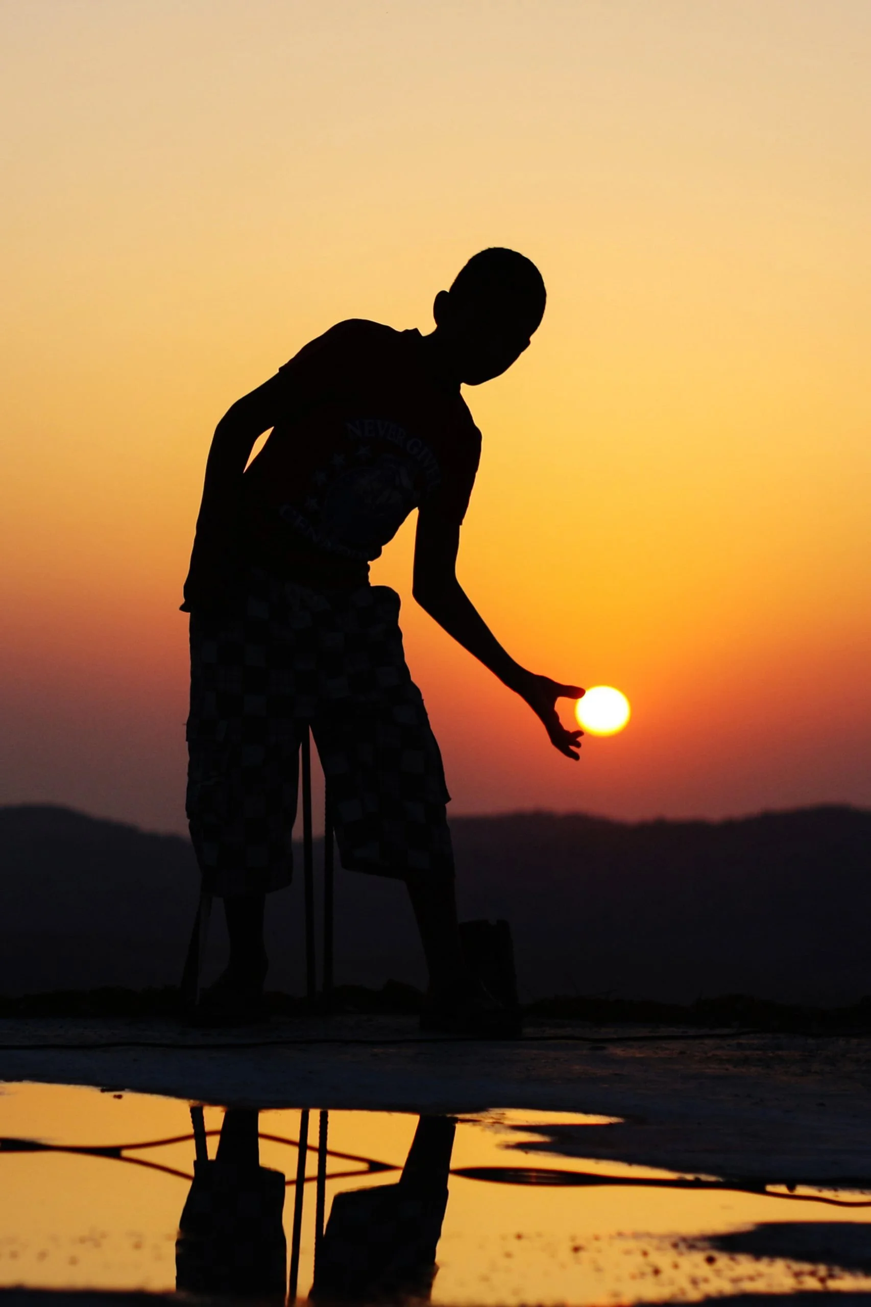 Silhouette of a lamplighter holding the setting sun like a lantern - Capture the Spirit of Ramadan collection
