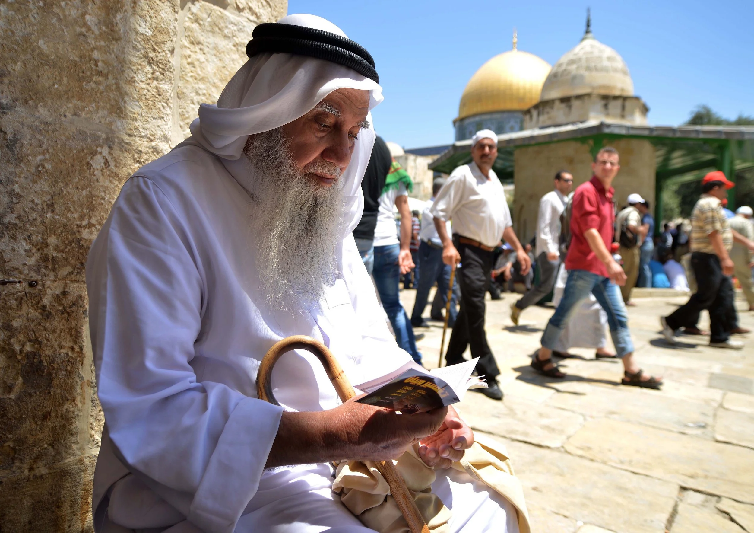 Elder reading beside the Dome of the Rock, Jerusalem - photograph by Mahmoud Ilean