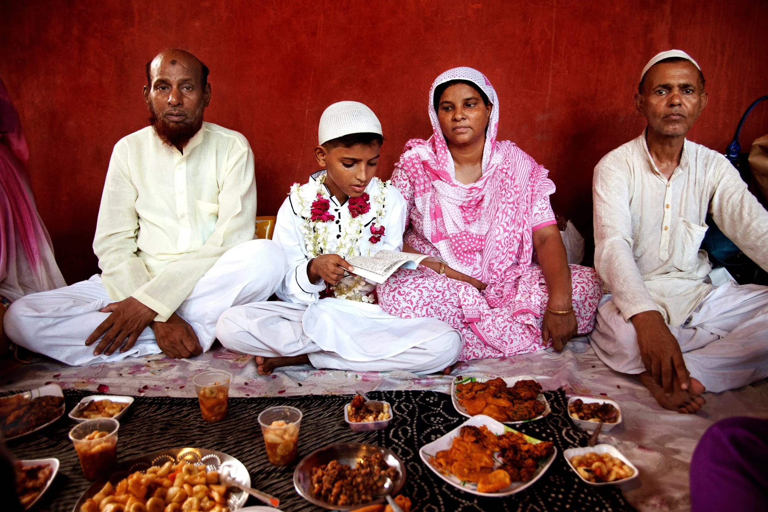 Family iftar against a red wall - photograph by Sourav Karmakar, India, Capture the Spirit of Ramadan collection