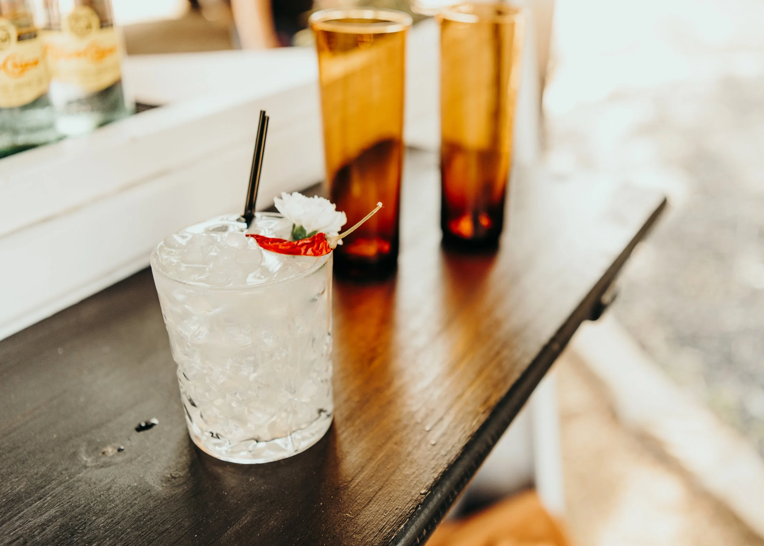 Guests laughing at the bar window while taking celebratory shots