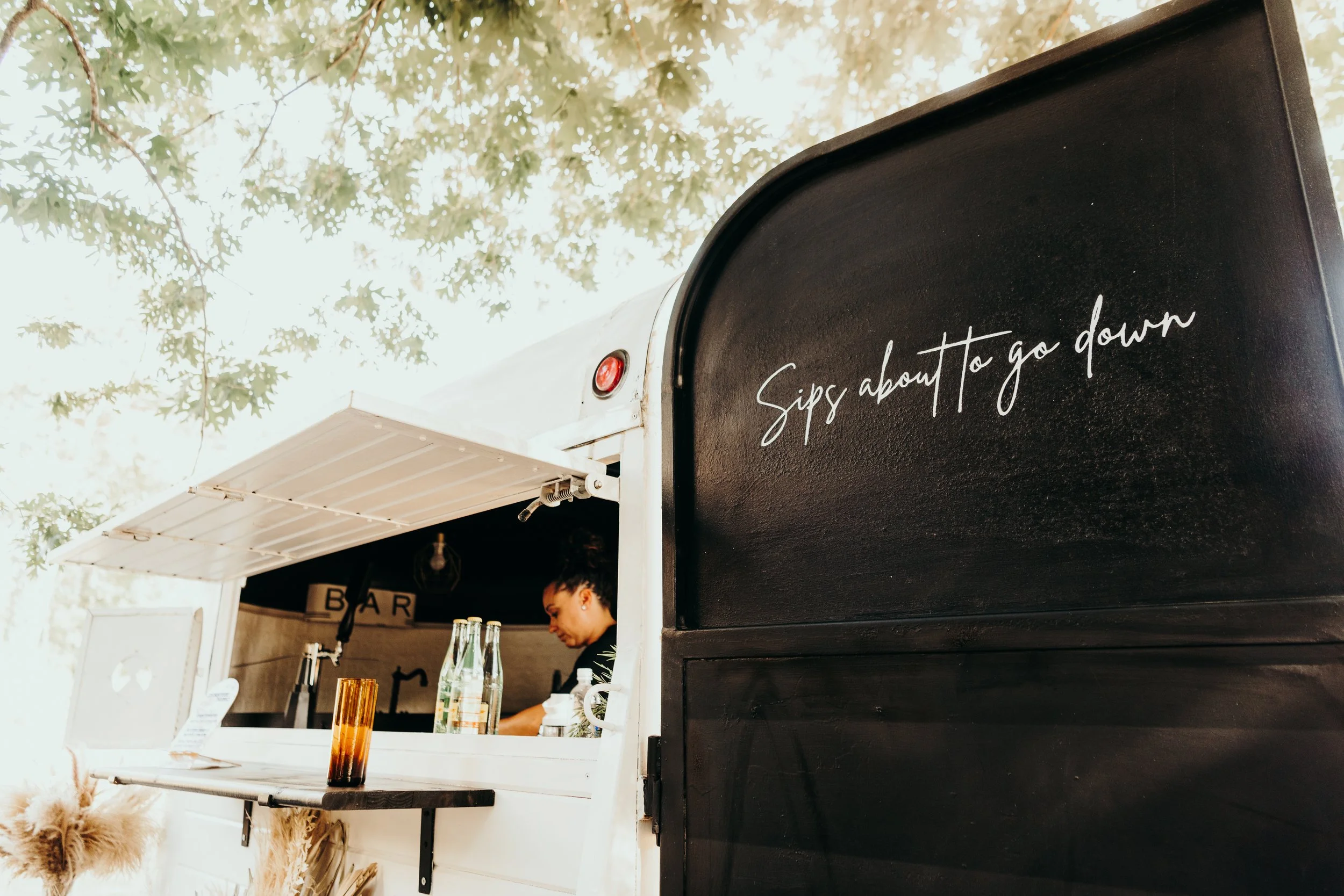 Bar side door with script: Sips about to go down