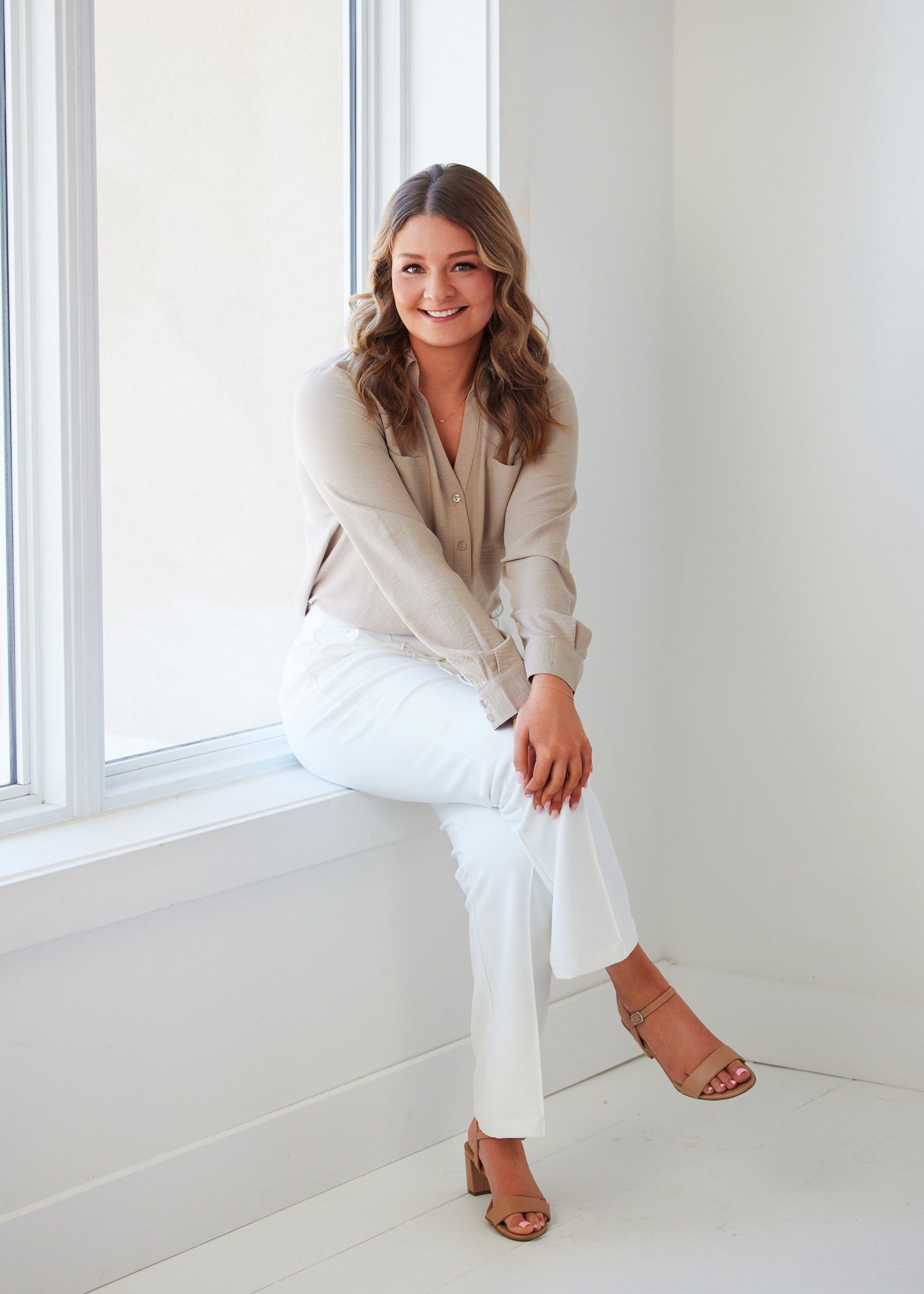 Hunter Hamblin smiling confidently against a chic interior set during her personal branding session in Kansas City