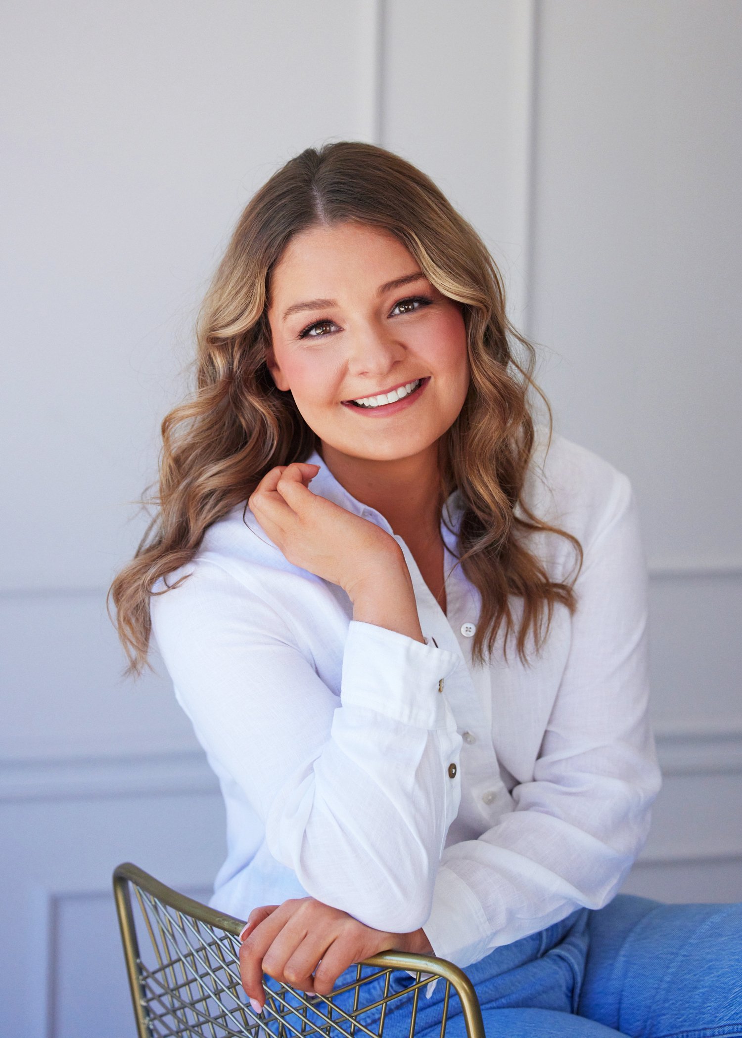 Hunter Hamblin laughing naturally during a Kansas City branding photo session, showcasing genuine connection and joy