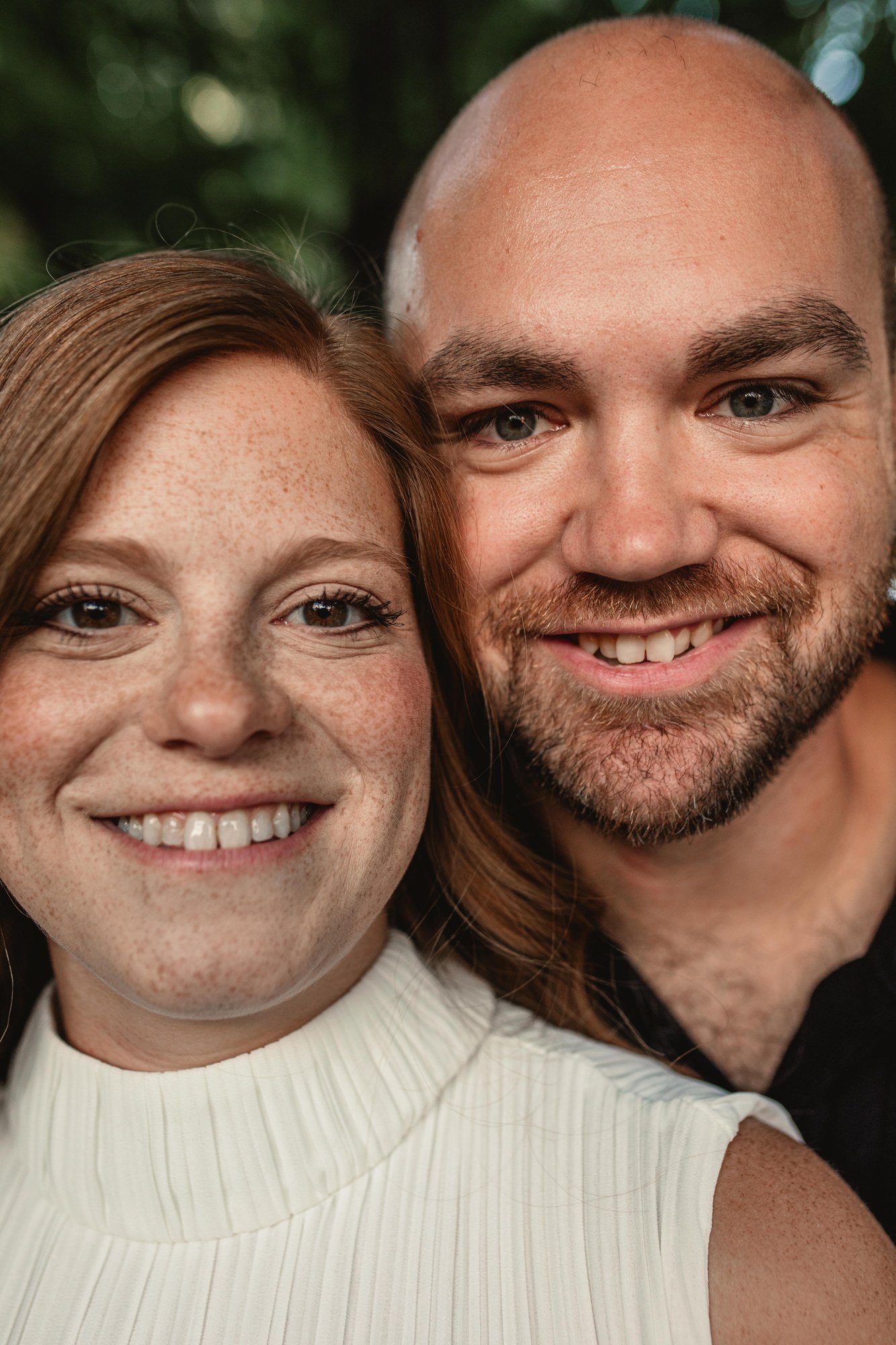 Close-up of Jacob and Erin smiling together at the camera.