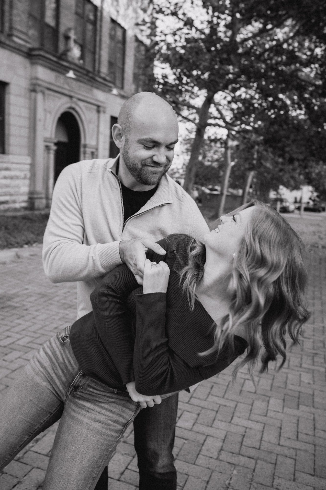 Black-and-white photograph of Jacob supporting Erin in a playful dip.