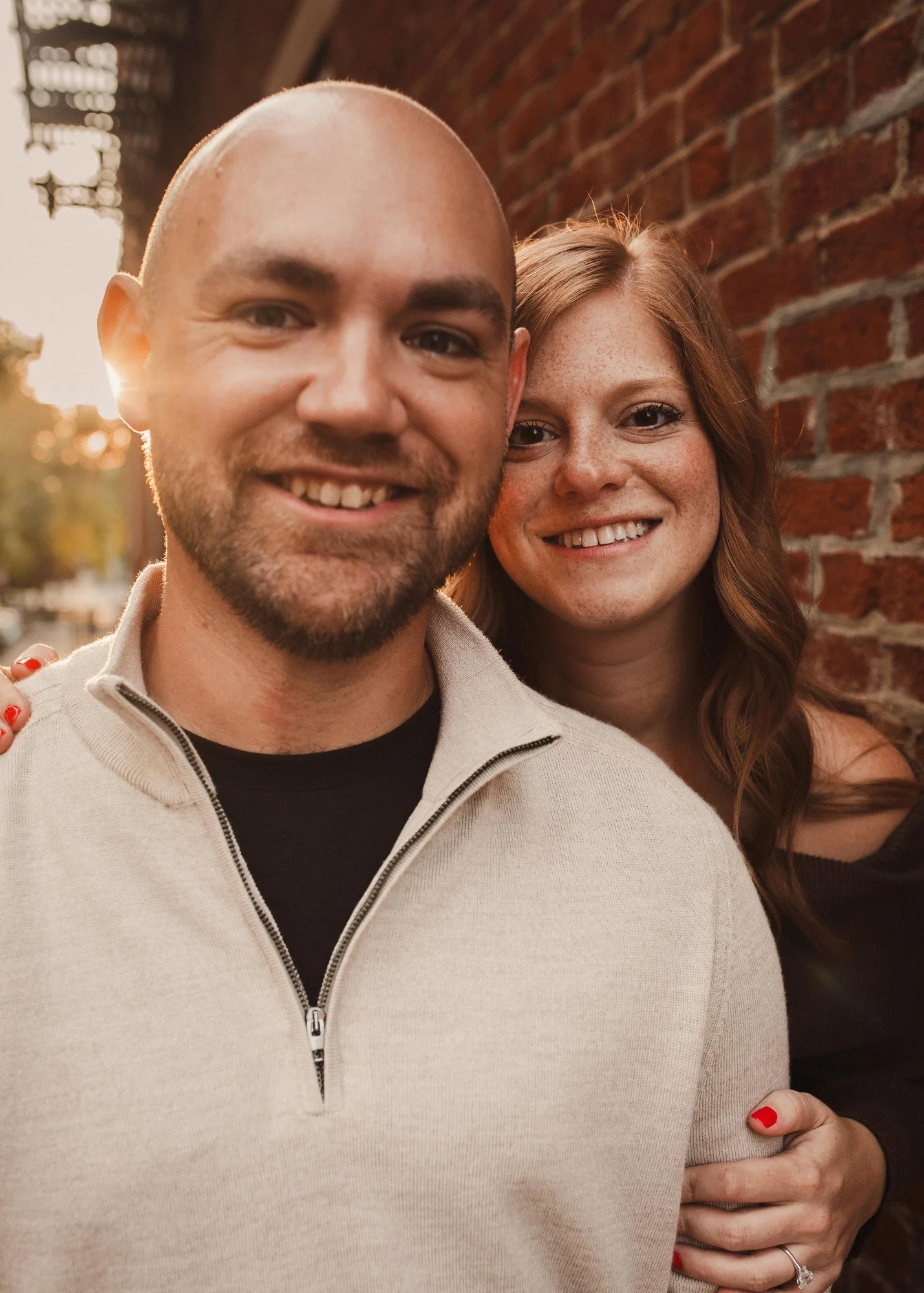 Erin embracing Jacob from behind as they smile at the camera.