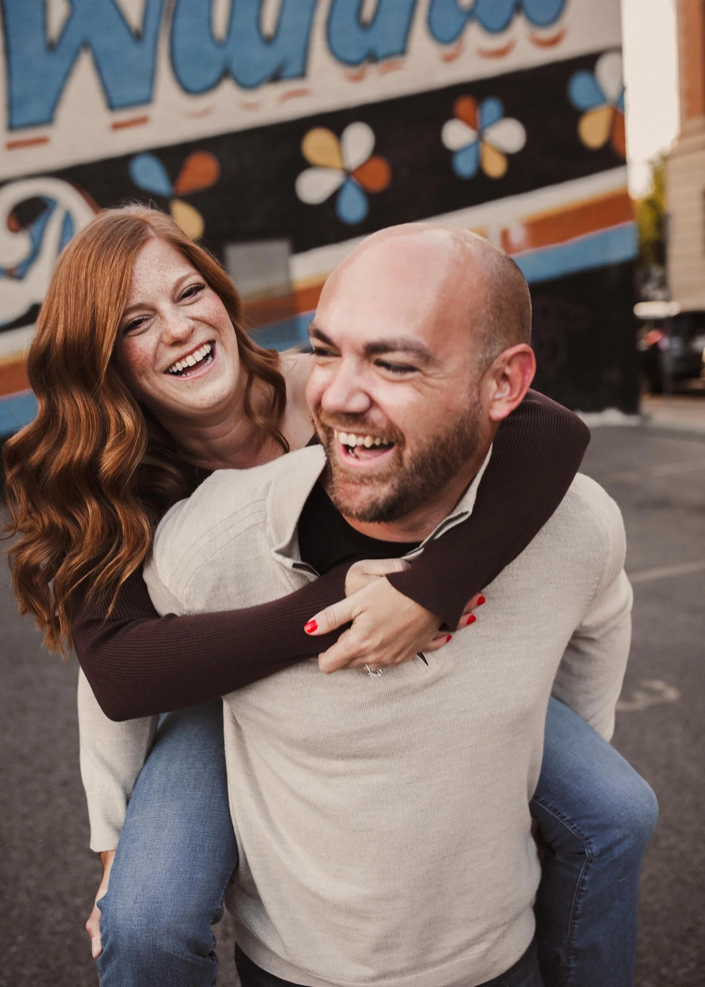 Erin laughing as Jacob carries her on his back.
