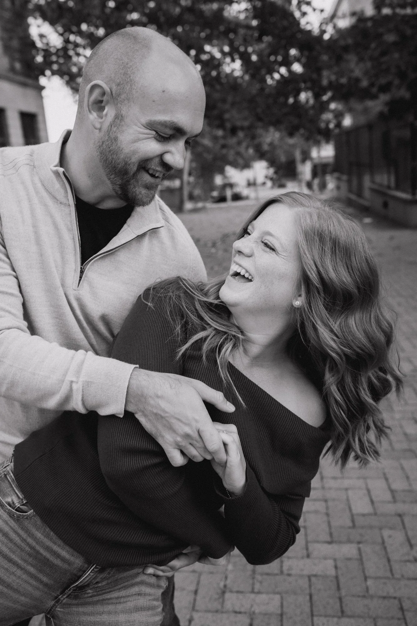 Black-and-white photograph of Jacob dipping Erin as they smile at each other.