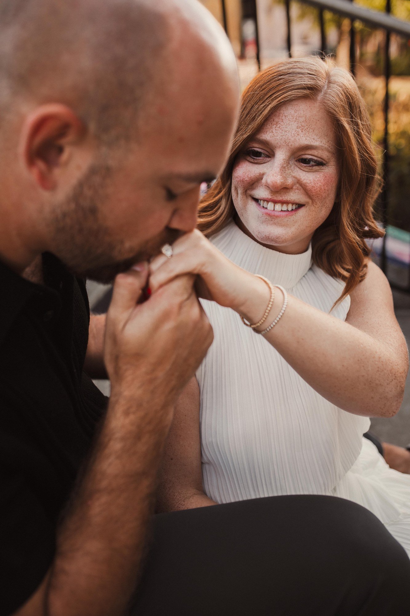 Jacob kissing Erin’s hand as she smiles.
