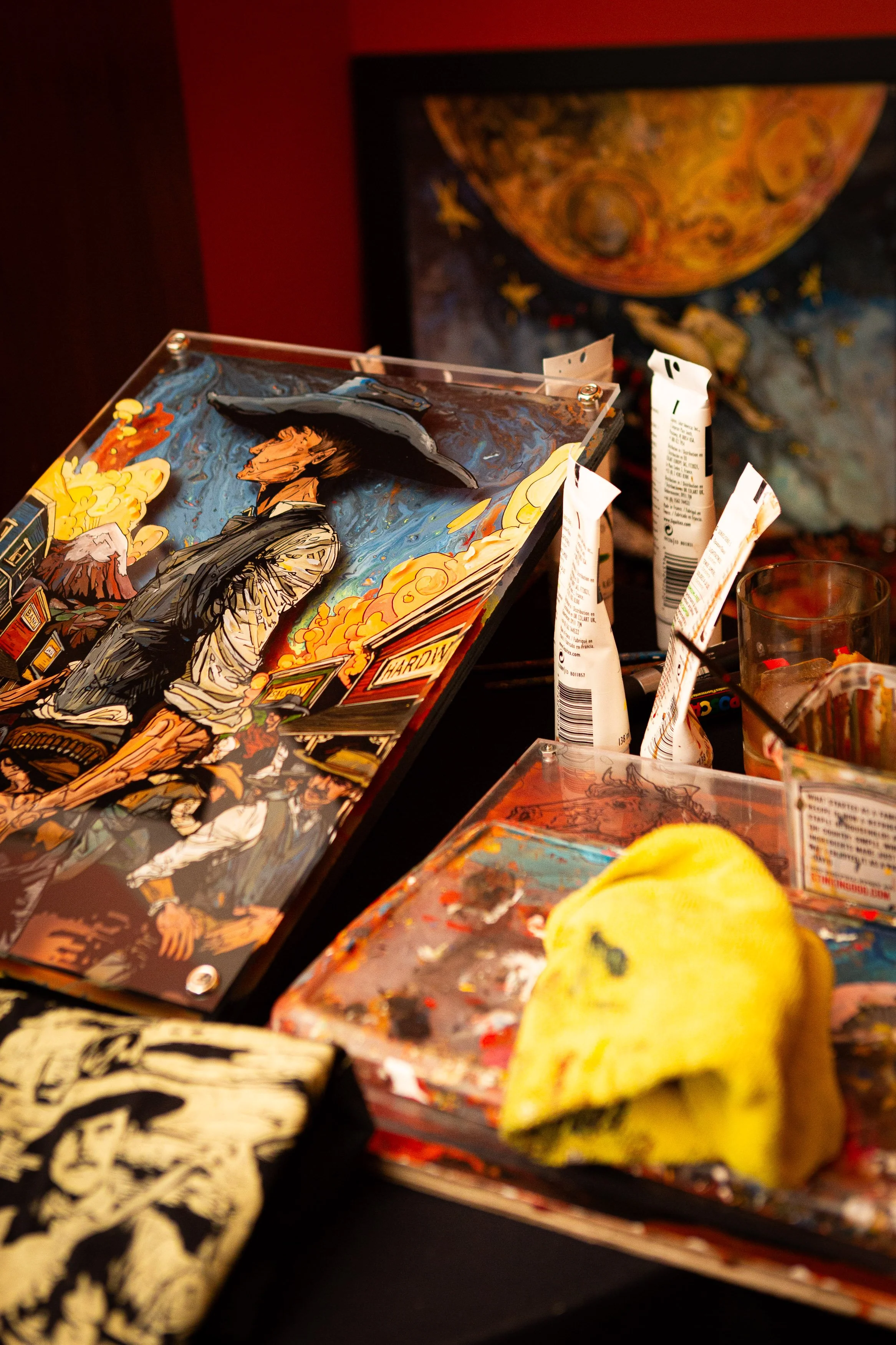 Cody Kuehl's artwork and festival posters displayed for sale at the Go West Film Festival merchandise table