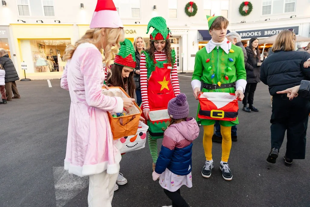 Holiday characters greeting families