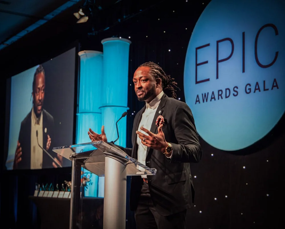 Leadership keynote speaker Attah Obande speaking from the podium at the EPIC Awards Gala