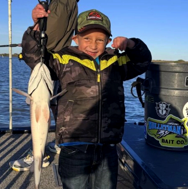 Young angler holding a redfish during a Rockport half-day fishing trip