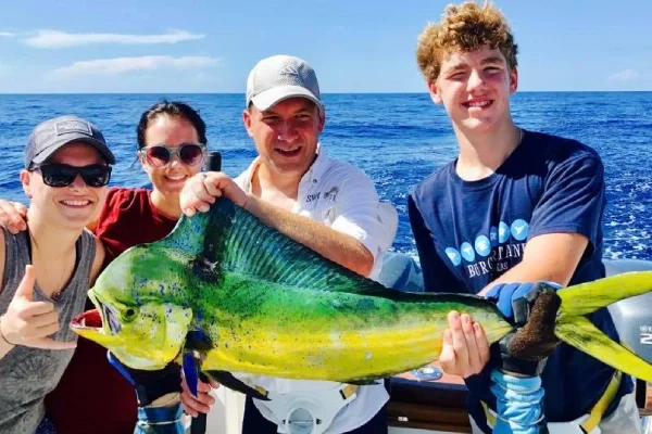 Texas Crew'd offshore charter guests holding a mahi-mahi