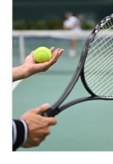 Photograph of tennis ball and racquet just before player prepares to serve