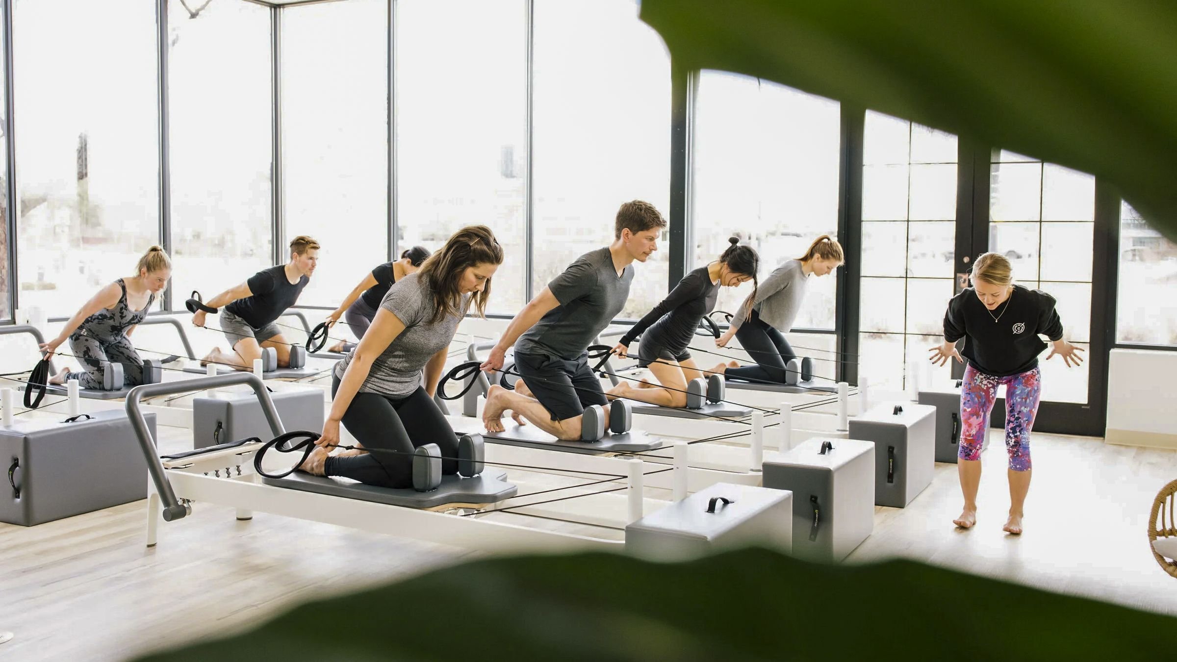 A sunlit reformer class at Care·To Pilates
